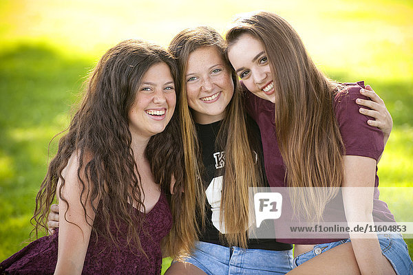 Portrait of smiling teenage girls hugging