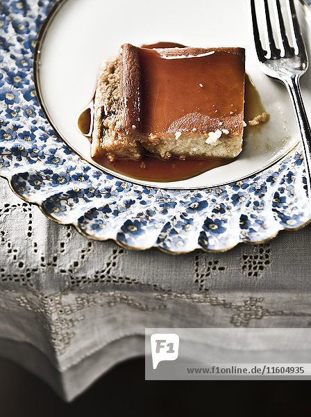 Flan on plate with syrup and fork