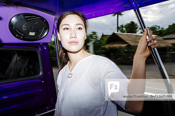 Mixed Race woman riding bus in Bangkok  Thailand