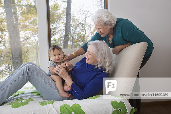 Grandmothers playing with baby grandson