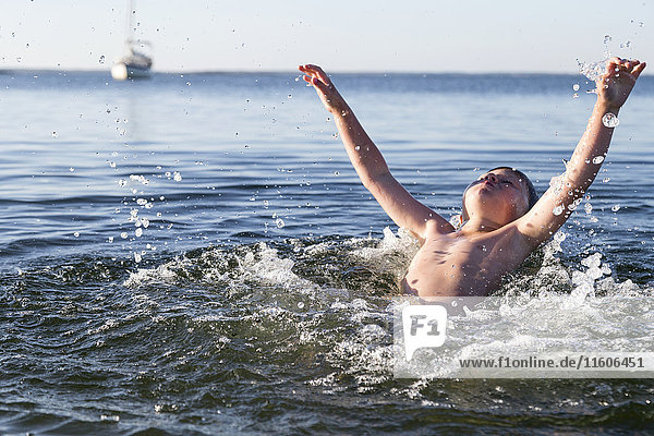 Boy splashing in lake