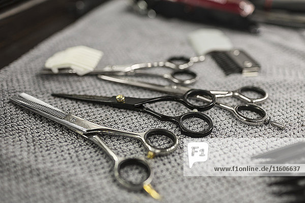 Close-up of various scissors on napkin at hair salon