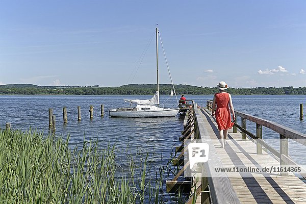 Woman on boat dock on Lake Ratzeburg  Groß Sarau  Schleswig-Holstein  Germany  Europe
