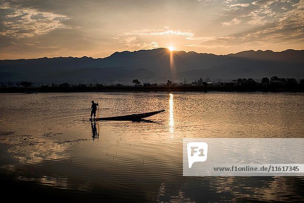 Fisherman working at the Tharzi Pond at sunset time  Nyaungshwe  Myanmar.