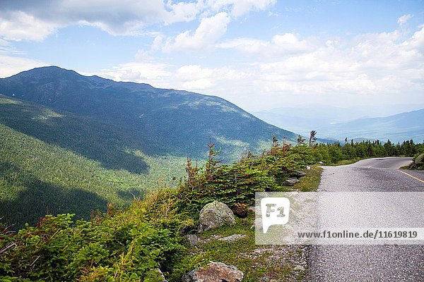Gorgeous landscape of Mont Washington in NH. The road lead to the mountains and to The view of the tower of Mount Washington  New Hampshire  the highest peak in the Northeastern United States at 6  288 ft.