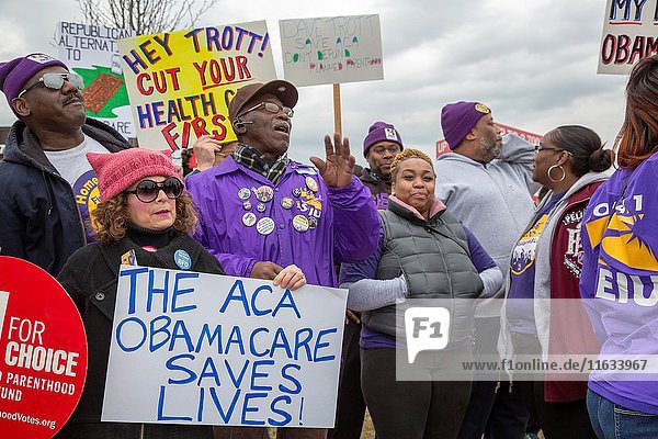 Troy  Michigan USA - 21 February 2017 - Constituents picket the office of Republican Congressman Dave Trott  demanding that he hold a Town Hall meeting so they could make known their opposition to the planned repeal of Obamacare. They said the representative was a 'chicken' for traveling to India during the February Congressional recess rather than meeting with voters in his district.
