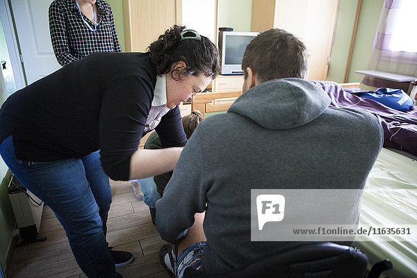 Reportage on a home health care service in Savoie  France. An auxiliary nurse sets up a VAC-type device for a patient with bedsores. The device treates wounds through negative pressure.