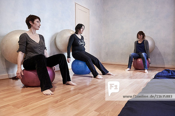 Reportage on a midwife in Lyon  France. Post-partum abdominal and pelvic floor group rehabilitation session. These exercises enable the women to feel their pelvic floor and become aware of its volume and elasticity in order to strengthen it. New born babies are welcome at these sessions.