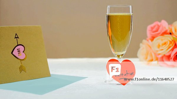 Glas Champagner mit Valentine Heart Message  Karte und Blumen auf Tisch 2