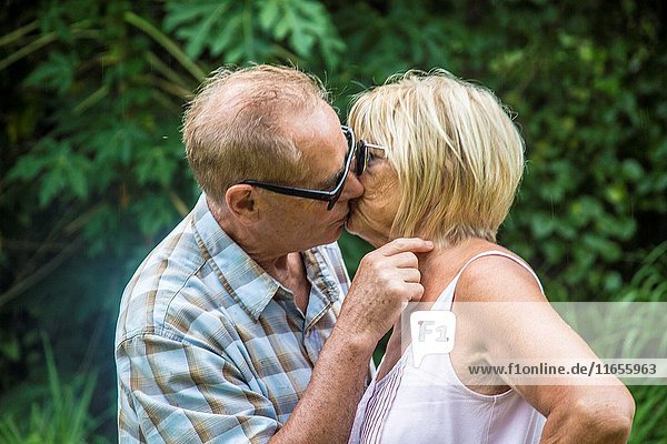 Older mature retired caucaisna couple talking and kissing.