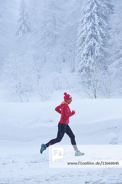 Female runner running in deep snow  Gstaad  Switzerland