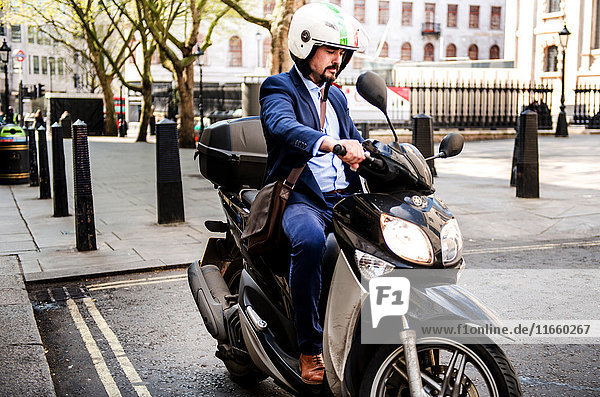 Businessman on motorbike  London  UK