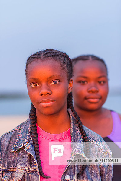 Portrait of two girls outdoors  at sunset
