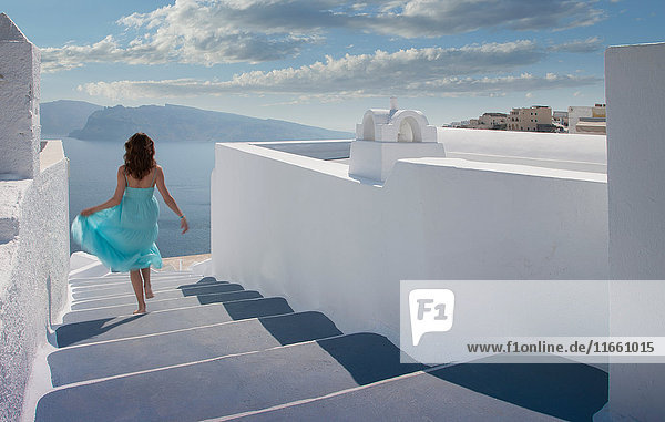 Frau  die eine Treppe hinuntergeht  Santorin  Kykladen  Griechenland