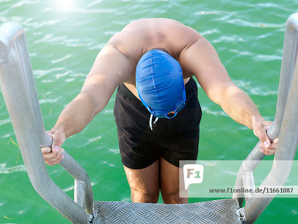 Swimmer on ladder into water Eastern Beach Geelong Victoria Australia