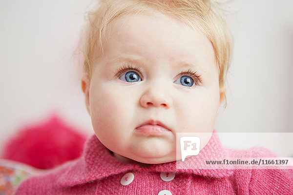 Portrait of baby girl  with bright blue eyes  close-up