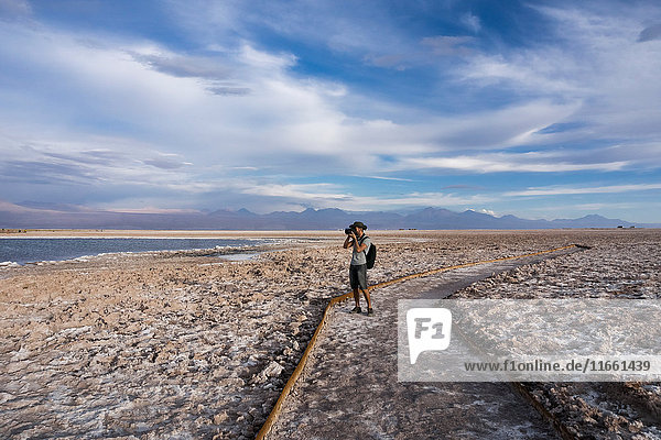 Photographer on snow covered landscape  San Pedro de Atacama  Chile