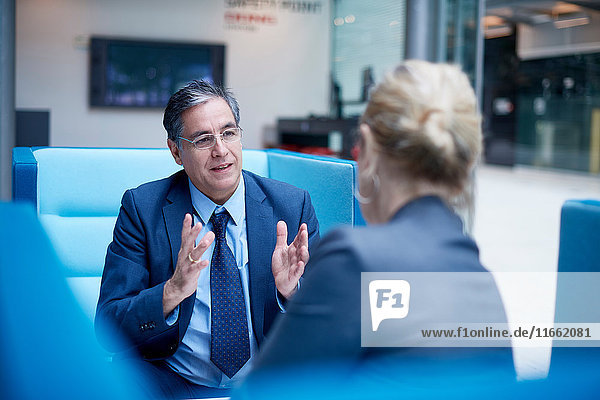 Businesswoman and man at meeting in office