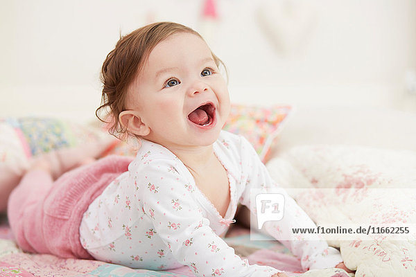 Porträt eines kleinen Mädchens  auf der Vorderseite liegend  lachend