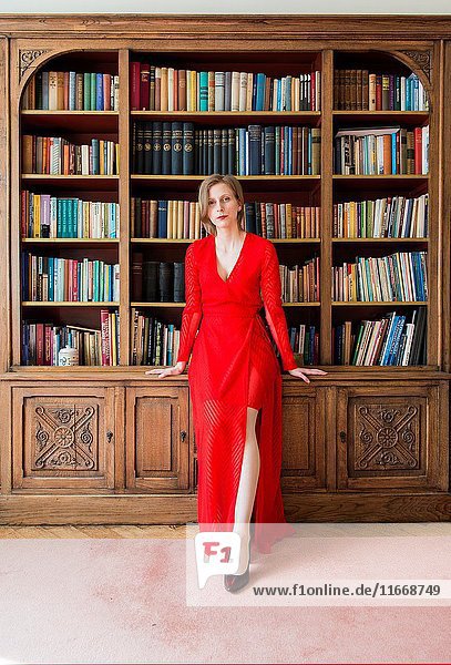 Tilburg  Netherlands. Woman in Red inside her vintage reading room library.