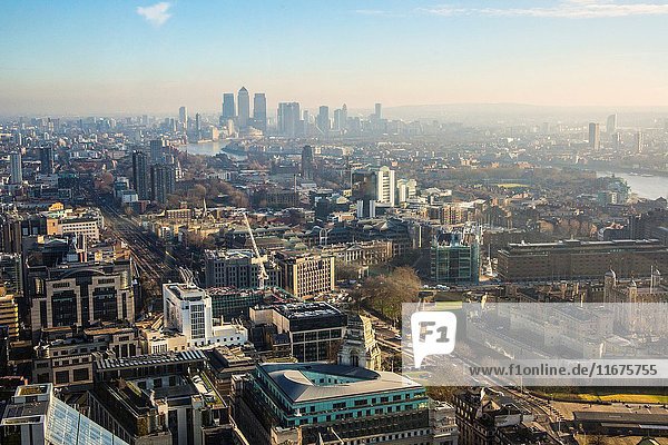 Aerial view of London with Canary Wharf in the background.