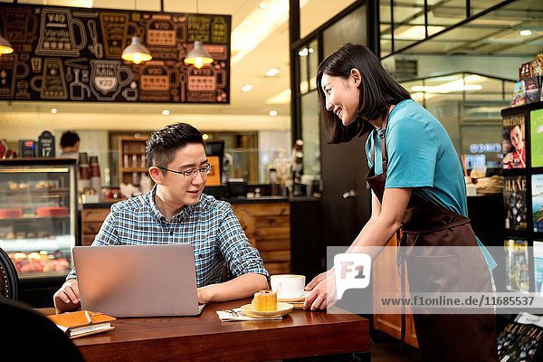 The waiter and the customer in the cafe
