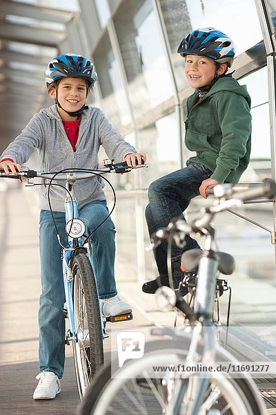 Children talking on bicycles in tunnel