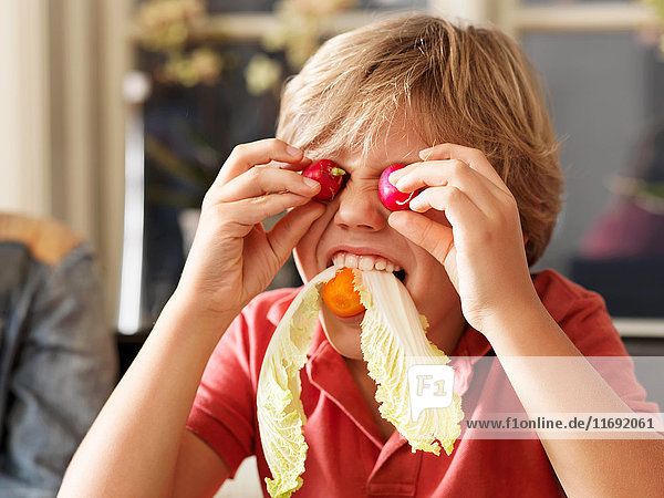 Boy playing with healthy food