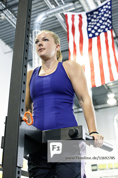 Woman working out in gym with american flag