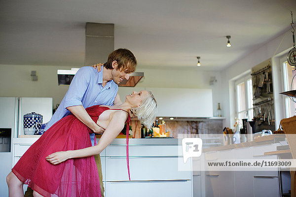 Couple dancing together in kitchen