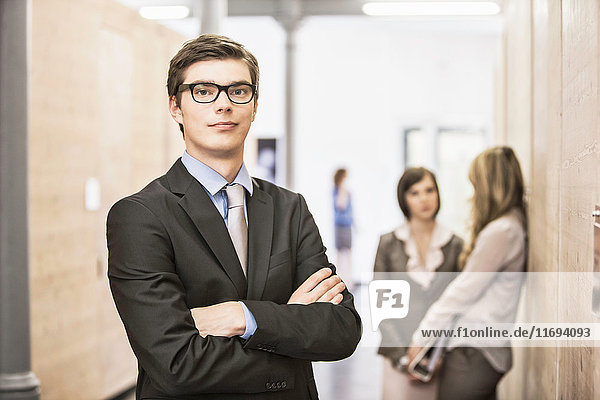 Businessman standing in hallway