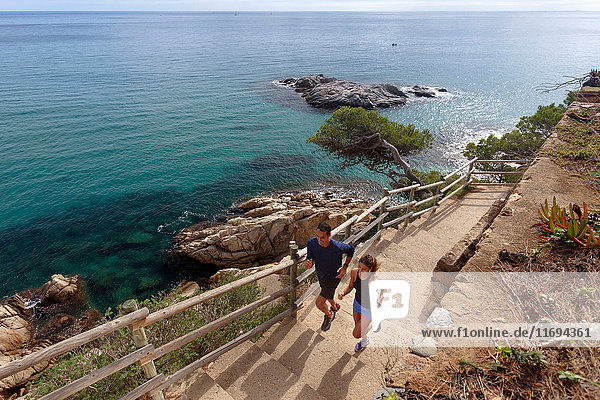 Couple running on paved steps
