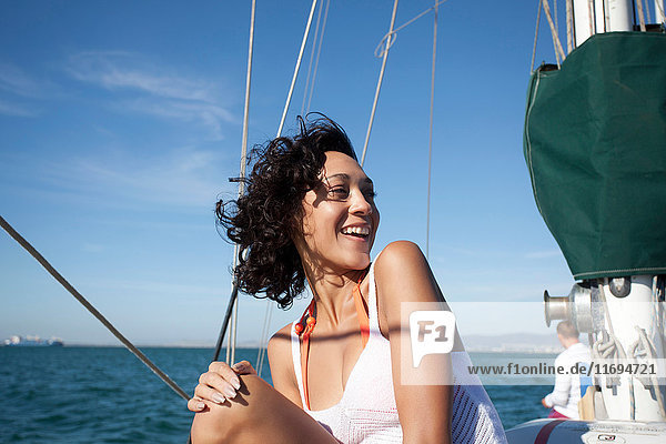 Young woman on yacht looking away