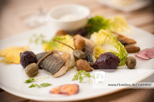 Plate of fish with salad and olives