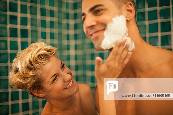 Woman helping boyfriend shave