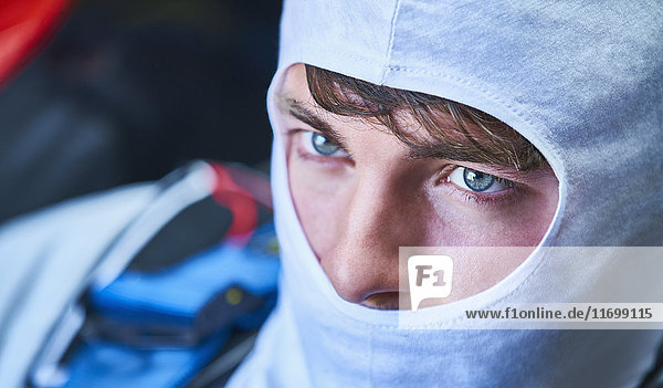 Close up serious race car driver wearing protective mask