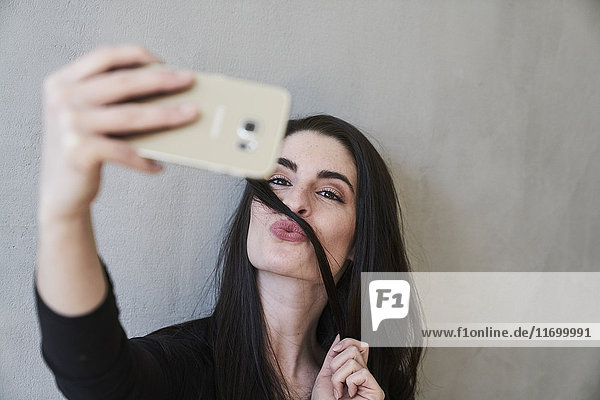 Young woman pouting taking a selfie