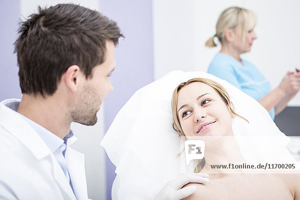 Aesthetic surgery  doctor talking to woman