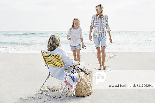 Mother daughter and grandma spending a day on he beach