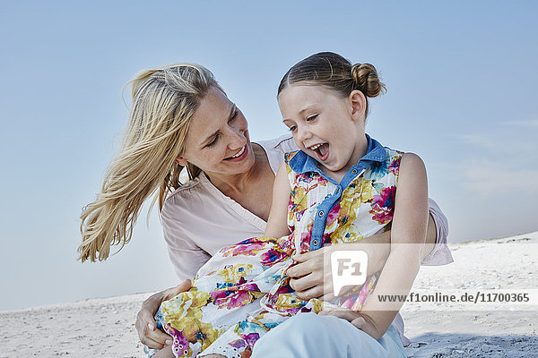 Happy mother with daughter on the beach