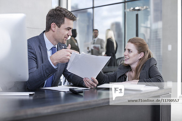Businessman talking to woman in office