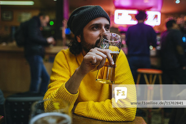 Man with glass of beer in a pub