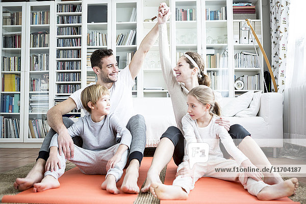 Happy family doing gymnastics at home