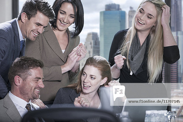 Group of happy with laptop in boardroom