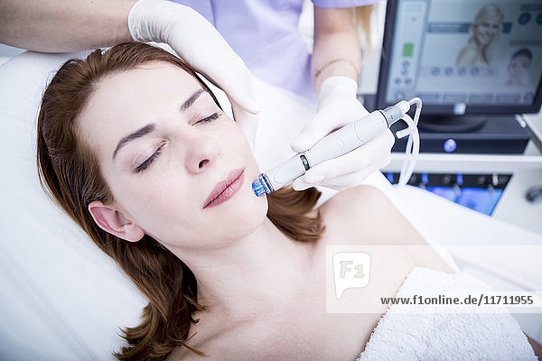 Aesthetic surgery  woman receiving facial cleaning