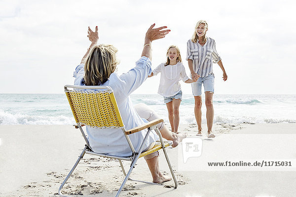Mother daughter and grandma spending a day on he beach