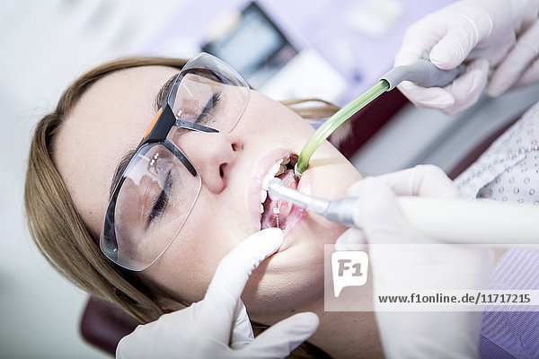 Woman at the dentist receiving root canal treatment