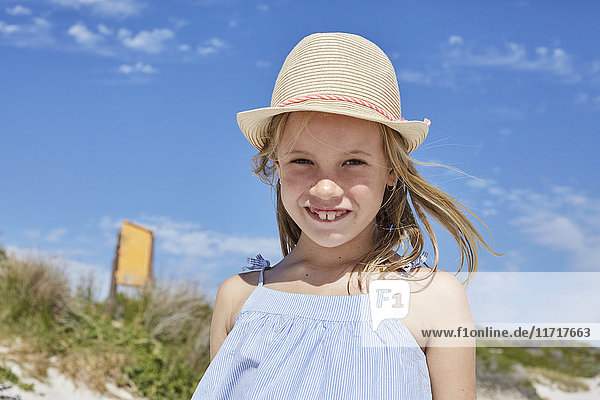 Little girl wearing a straw hat