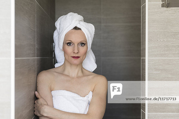 Portrait of smiling woman wearing towels in the bathroom