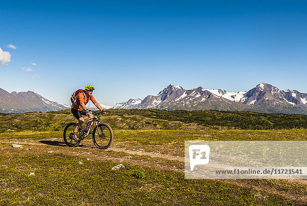 A man riding a mountain bike on the Lost Lake Trail near Seward  Southcentral Alaska  USA